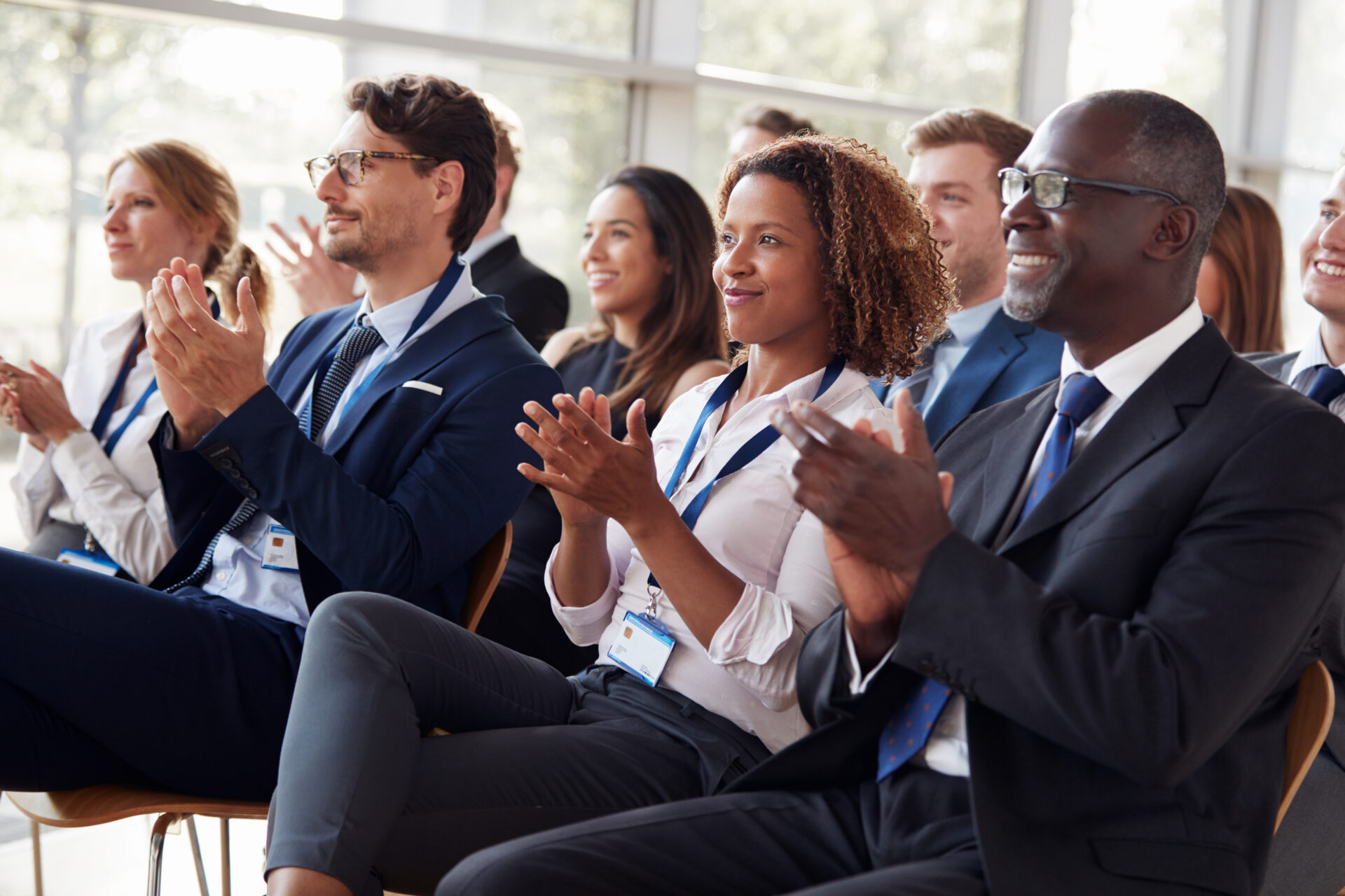 smiling audience applauding at a business seminar